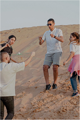 Desert team building activities in Dubai with corporate team participating in outdoor collaboration exercises